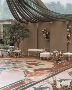 an indoor wedding venue decorated with flowers and greenery