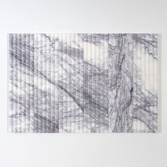 a piece of art that is made out of white and grey marbles on the wall