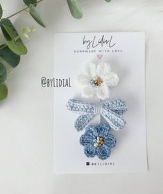 three crochet flower hair clips on top of a card