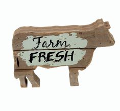 a wooden sign that says farm fresh with a cow on it's back side