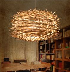 a wooden chandelier hanging from the ceiling in a room with bookshelves