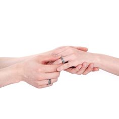 two people holding each other's hands with their fingers