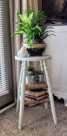 a small white table topped with a potted plant