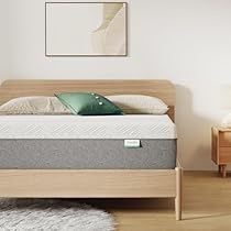 a bed with a wooden frame and mattress in a room next to two nightstands