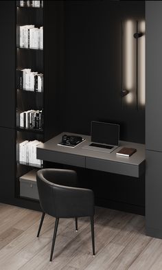 a desk with a laptop on it in front of a book shelf and chair next to it