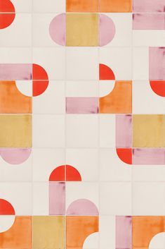 an orange, pink, and yellow pattern with circles on white tiles in different colors