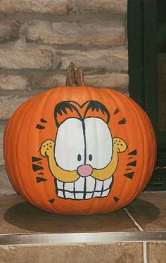 a pumpkin decorated to look like garfield the cat