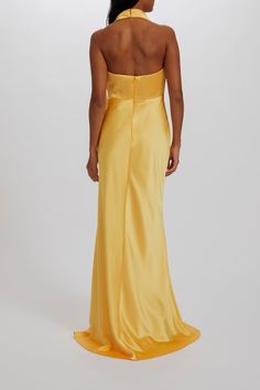 the back of a woman wearing a yellow dress