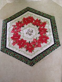 a white and black table cloth with poinsettis in the center on it