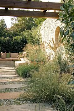 A vibrant Mediterranean garden with colorful flowering plants in full bloom. Garden Slope Ideas, Mediterranean Garden Ideas, Garden Slope, Tuscan Courtyard, Garden Mediterranean, Flower Garden Ideas, Mediterranean Garden Design, Courtyard Ideas, Garden Hedges