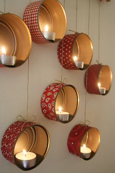 several hanging lanterns with lit candles in them