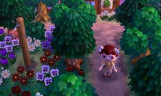 an animal crossing a path in the middle of some trees and flowers on a sunny day