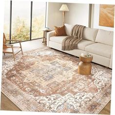 a living room with a couch, coffee table and large rug on the floor in front of a window