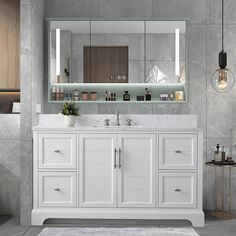 a white bathroom vanity with two sinks and large mirrors above it, along with a rug on the floor