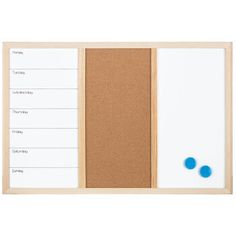 a cork board with two blue circles on it and a whiteboard attached to the back