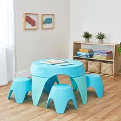 a child's play table and stools in a room with wood flooring