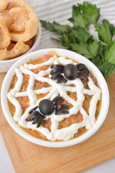 a white bowl filled with food on top of a wooden cutting board next to other foods