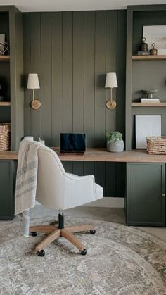 a chair sitting on top of a rug in front of a desk with bookshelves