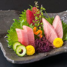 a plate that has some kind of food on it with watermelon, cucumber and lettuce