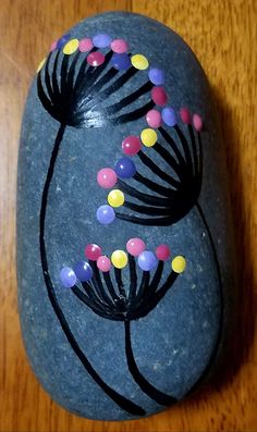 a rock with flowers painted on it