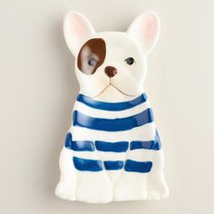 a ceramic figurine of a dog wearing a blue and white striped shirt with brown ears