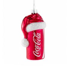 coca - cola can ornament with santa hat hanging from it's side