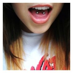 a close up of a person's mouth with long, straight hair and red lips