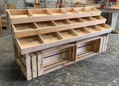 a wooden work bench with multiple compartments on it