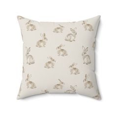 a white pillow with rabbits on it