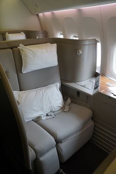 an airplane seat with pillows on it