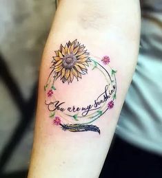 a sunflower with the words you are my sunshine written on it and a feather