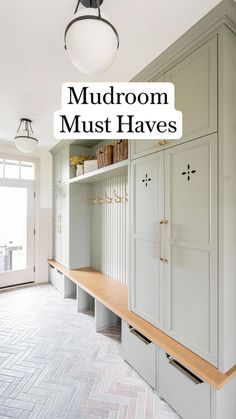 a hallway with white cabinets and wooden bench