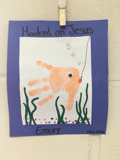 a paper cut out of an orange octopus holding a fishing hook with the words hooked on jesus