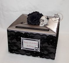 a black box with a skull and a rose on the top that says happy birthday