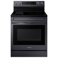 a black oven with the door open and an electric stove top in front of it