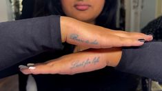 a woman is holding her hand up with the word faith on it, in front of her