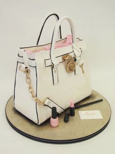 a white handbag cake sitting on top of a table