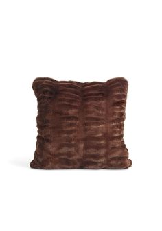 a brown fur pillow on a white background