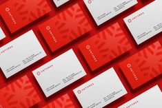 red and white business cards with snowflakes on the front are arranged in rows