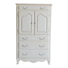 an antique white armoire with two doors and drawers on the bottom shelf, against a white background