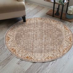 a round rug with an ornate design on the floor