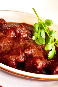 a bowl filled with meat and garnished with cilantro