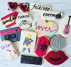 decorated cookies are arranged in the shape of women's names and other things on display