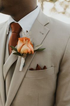 a man in a suit with a boutonniere on his lapel