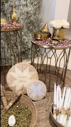 candles and other items are on display in front of a christmas tree with white flowers