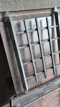 an old metal window with bars on it