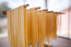 several pieces of pasta are lined up on a rack in front of a window,