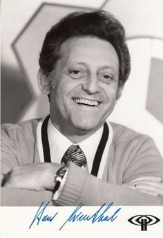 an old black and white photo of a smiling man with his arms folded over his chest