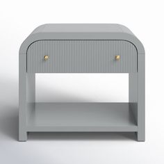 a grey nightstand with two drawers and gold handles on the top, against a white background