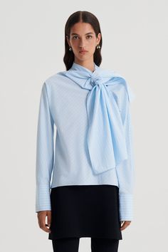 The Stripe Cravat Shirt reimagines signature silhouettes with feminine detailing. Crafted from 100% cotton, the shirt is adorned with an exaggerated cravat style necktie that can be fastened into a bow at the collarbone for alluring detail. Drawing influence from timeless tailoring codes, the pale blue shirt features a diagonal stripe print, deep cuffs and button detailing. Style with occasion silhouettes for a modern interpretation of event dressing or pair back with refined tailoring for a sophisticated ensemble. Detail Drawing, Scanlan Theodore, Diagonal Stripes, Event Dresses, Blue Shirt, Stripe Print, Necktie, Pale Blue, Neck Tie